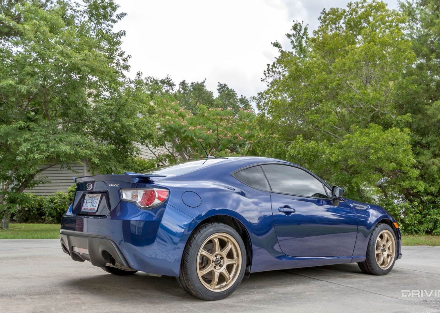 Subaru BRZ blue rear 3/4 on Nitto NT05 tires