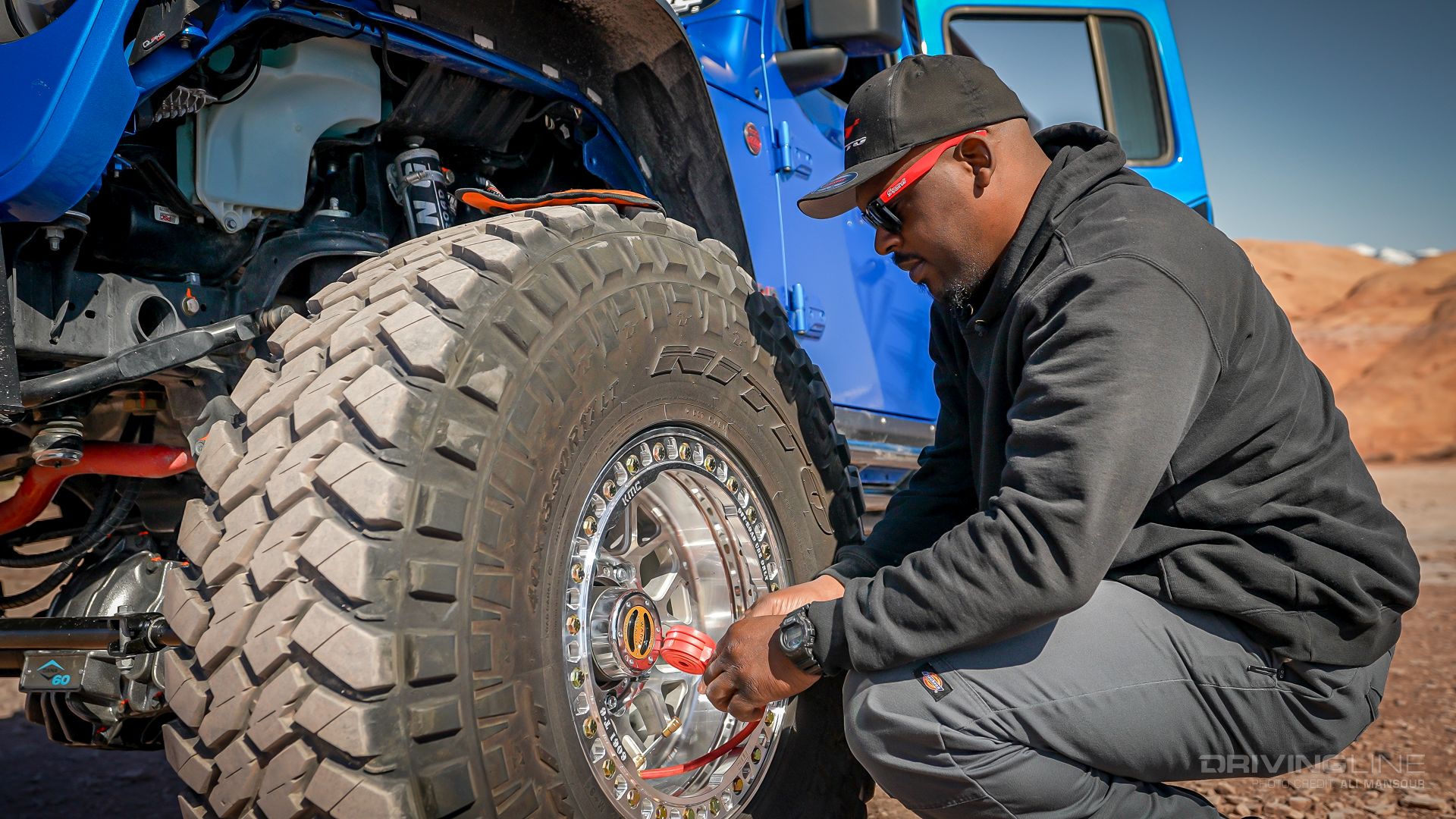 Jeep Gladiator Rubicon on 40s Overland Build checking tire pressure on Trail Grappler tires