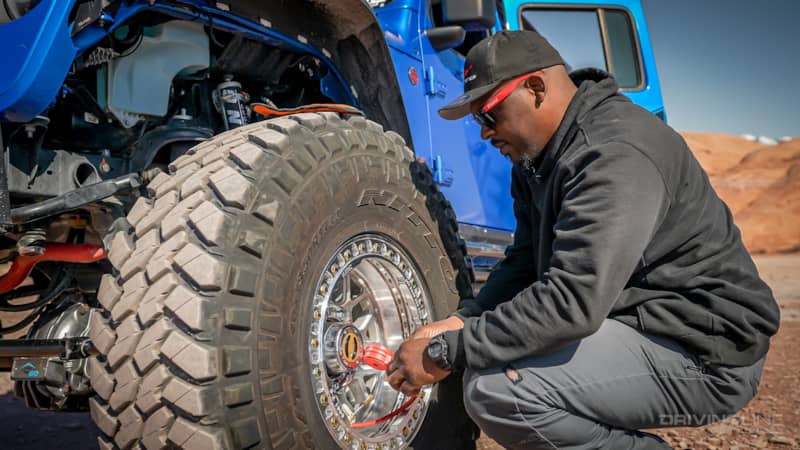 Jeep Gladiator Rubicon on 40s Overland Build checking tire pressure on Trail Grappler tires