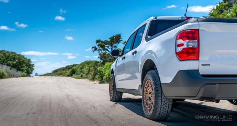 Nitto Nomad Grappler Crossover Terrain tire on white Ford Maverick on dirt road