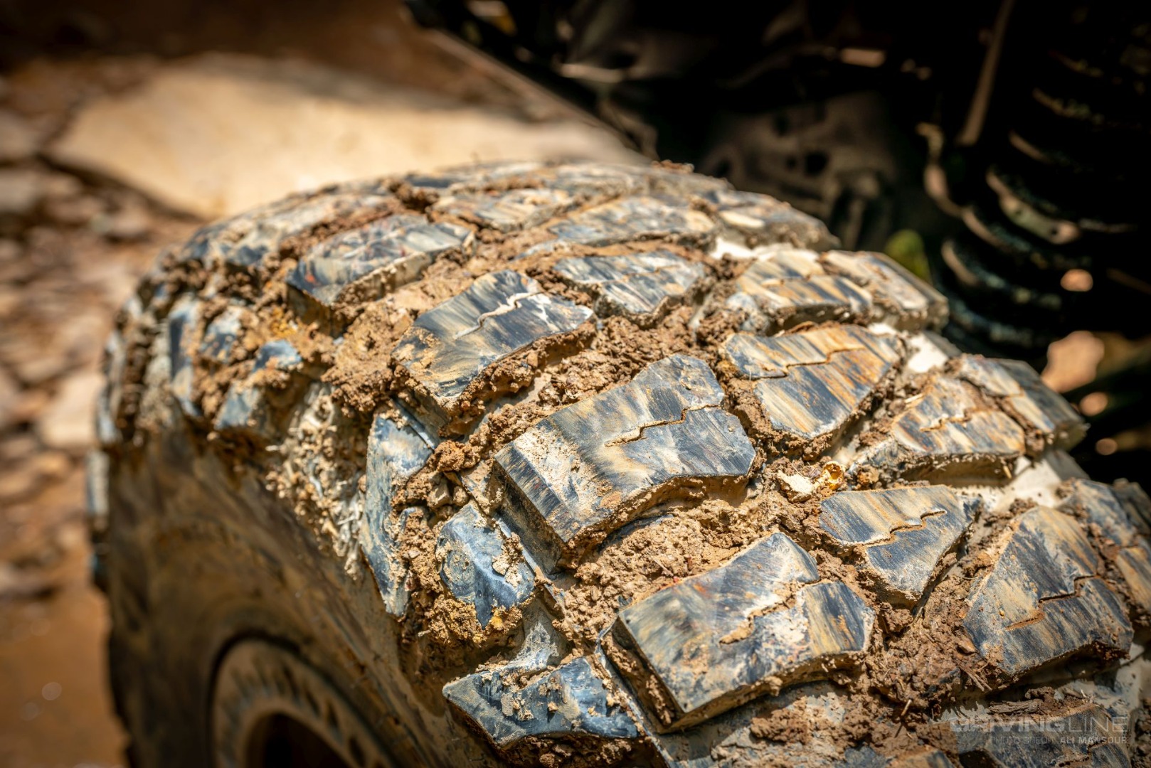 detail of mud within the tread blocks of nitto mud grappler tire