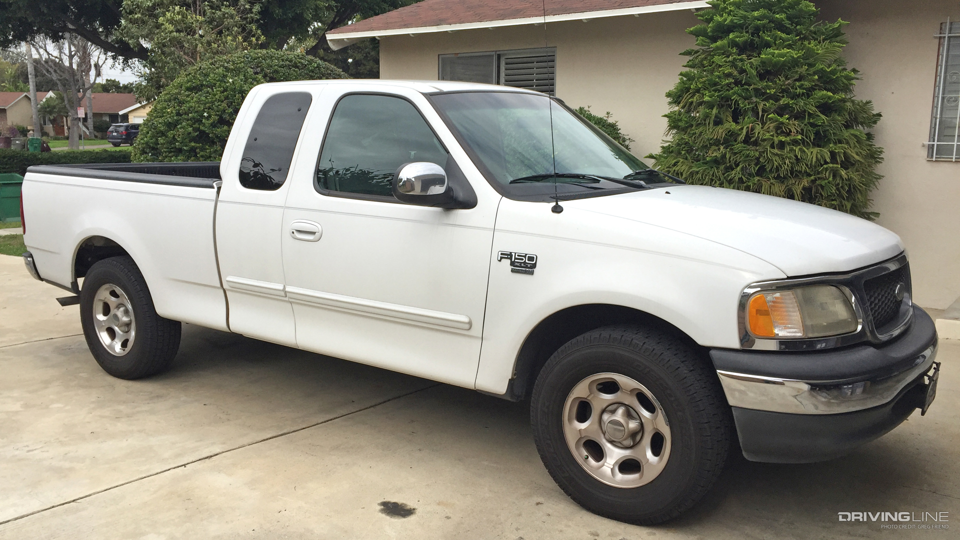 Before photo of passenger side of 2000 Ford F-150 XLT Truck in white