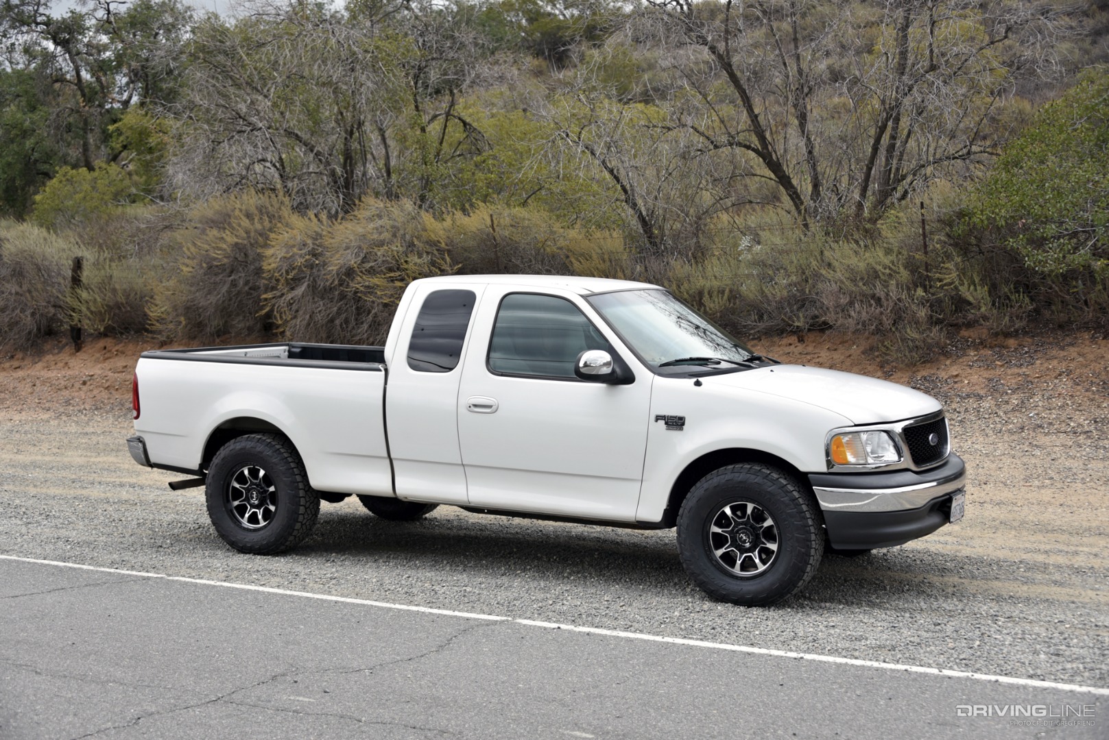Passenger side of white 2000 Ford F-150 on Recon Grappler A/T tires