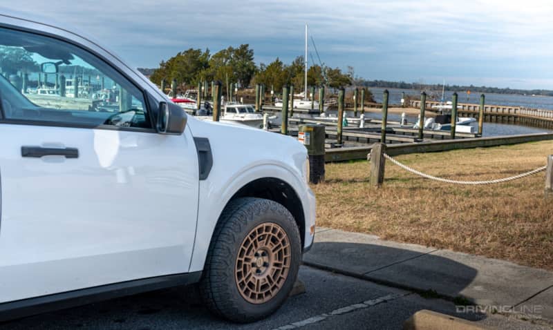 Front driver side of white 2022 Ford Maverick XL Hybrid on Nitto Tire Nomad Grappler