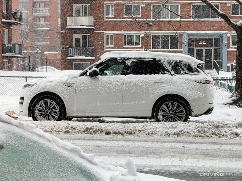 2023 Land Rover Range Rover Sport side profile covered in snow