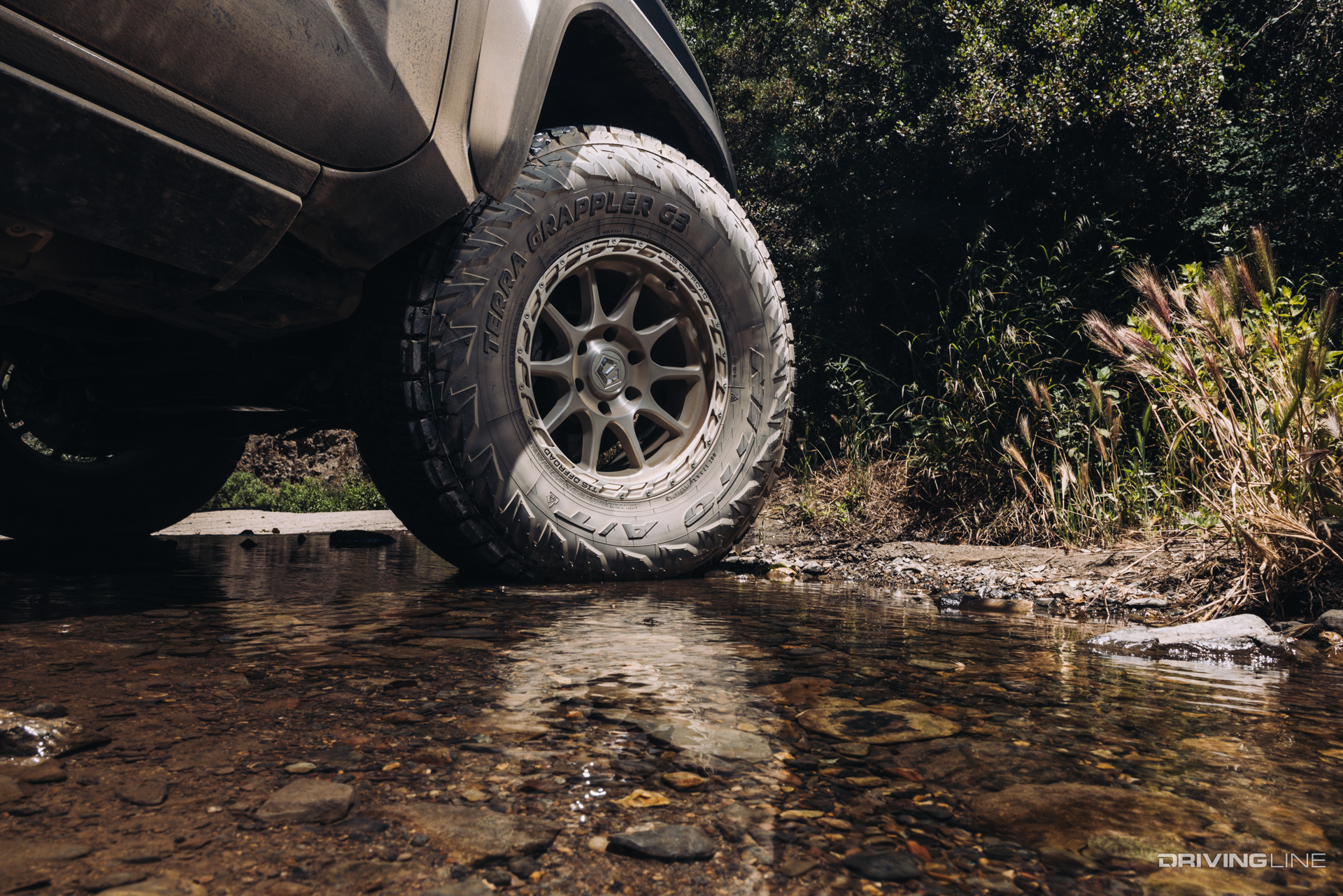 Nitto Terra Grappler G3 A/T Tire on a Toyota in a shallow stream