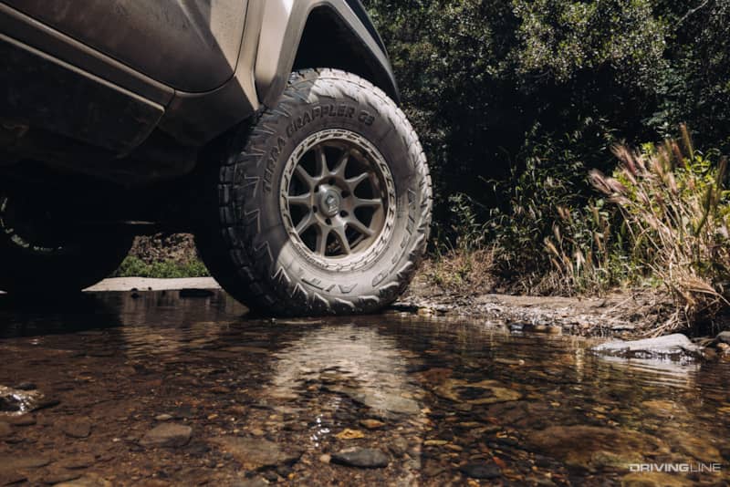 Nitto Terra Grappler G3 A/T Tire on a Toyota in a shallow stream