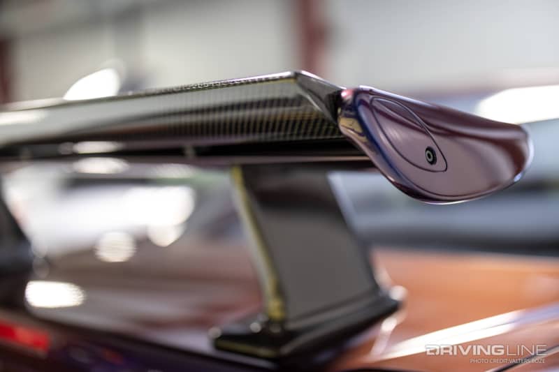 A carbon fiber middle wing element replaces a part of the rear R34 Skyline spoiler that was originally fiberglass