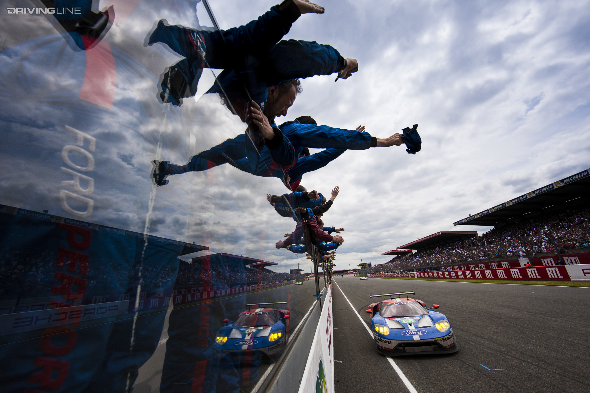 spectators wave to Ford GT at Le Mans 2016