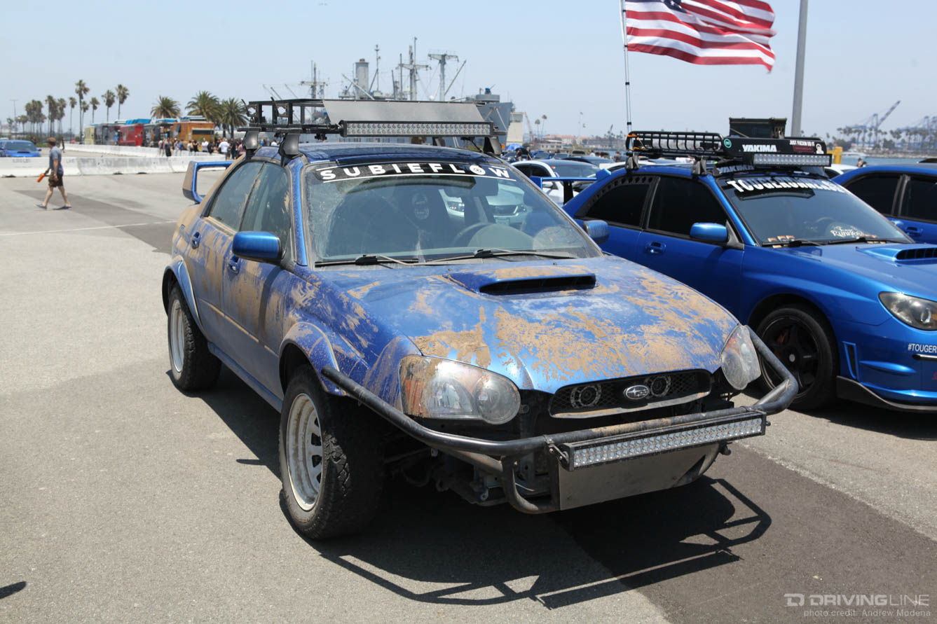 blue Subaru covered in dirt