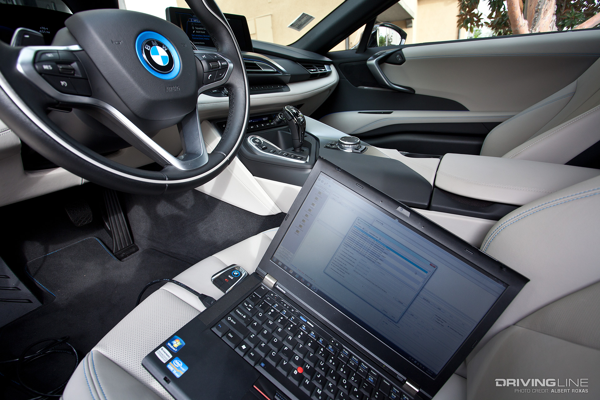 Laptop sitting in the front seat of a BMW
