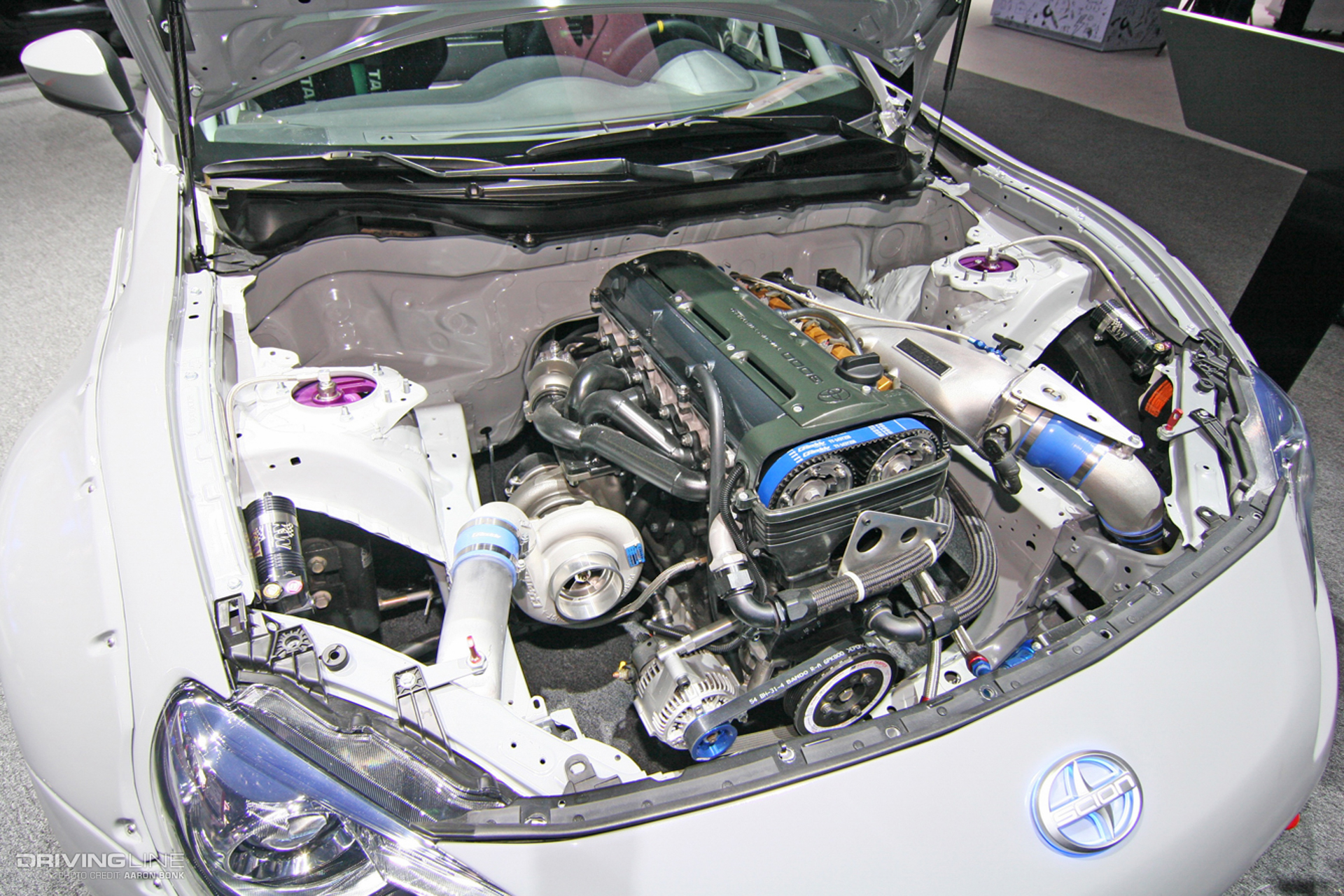 2JZ in the engine bay of a white Scion