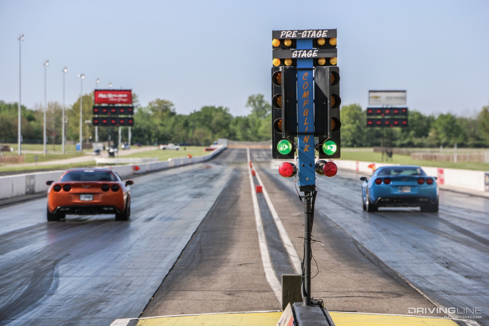 Two C6 Corvettes race down the drag strip