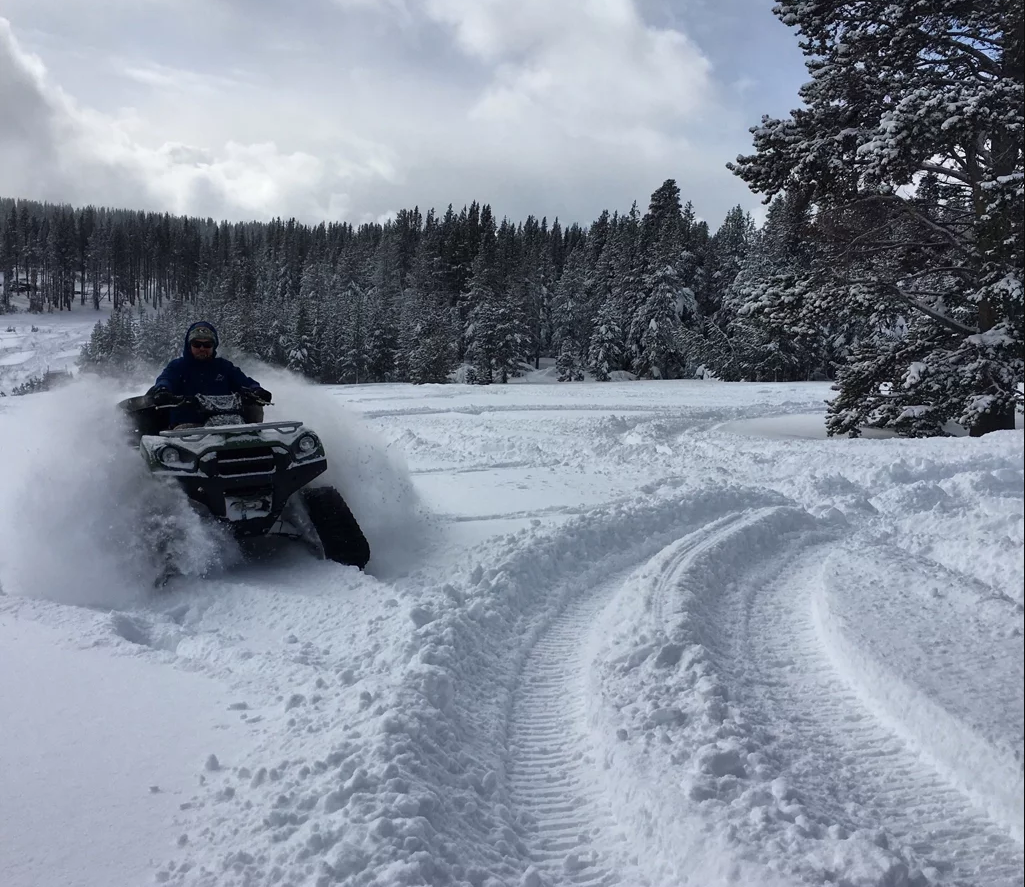 Nick Bailey riding his track-equipped ATV