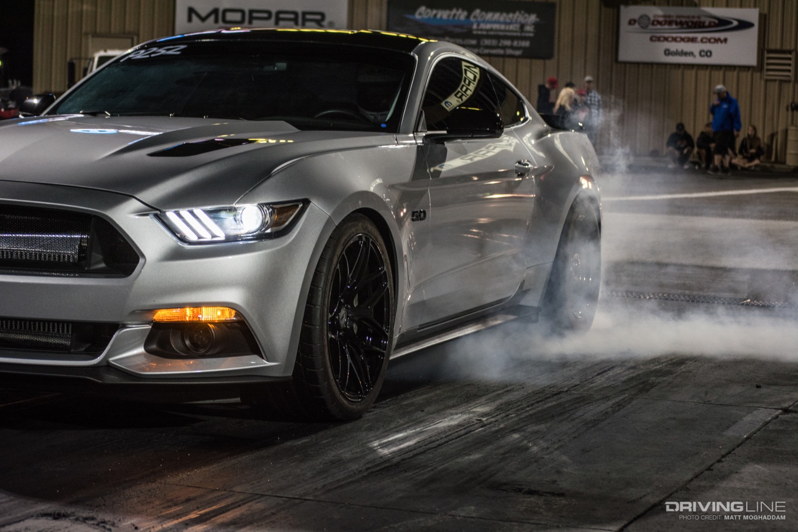 A Mustang warms up its tires in the water box