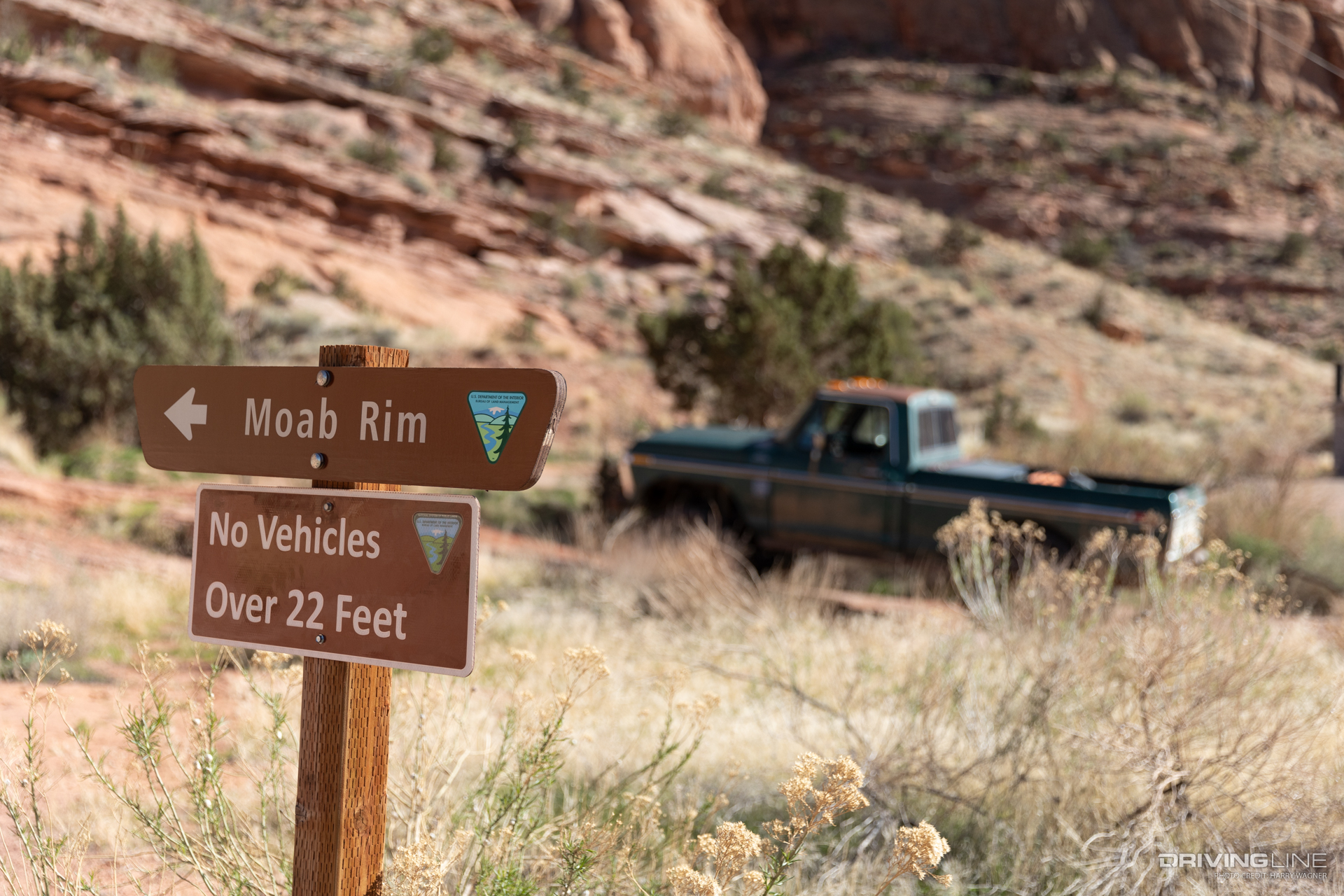 Moab Rim Trail marker with ford truck in background