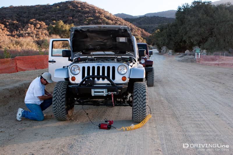 Airing up tires of Jeep Wrangler after a trail run