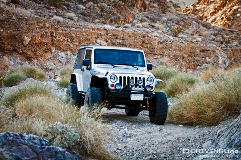Jeep Wrangler driving on a trail
