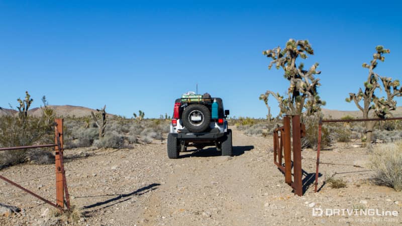 Jeep Wrangler driving through a gate