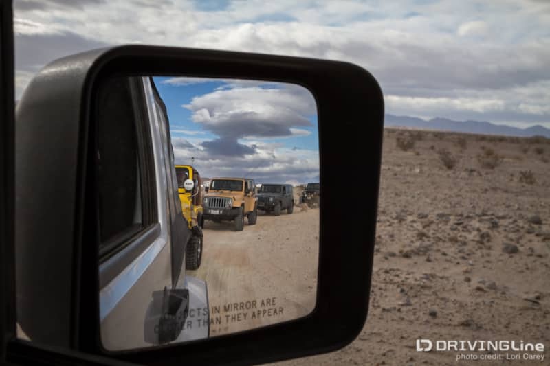 Four Jeep Wranglers in a side mirror