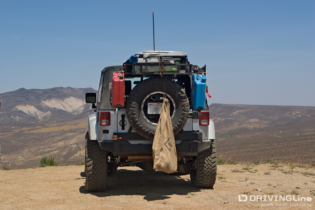 Jeep Wranlger with a trash bag on the back