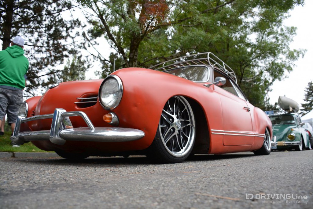 The low and steady Karmann Ghia is done up nostalgia style with a flat brick red paint, super slammed stance, and modern alloy wheels wrapped by low-profile tires.
