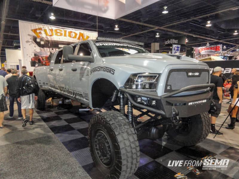 You have a Mega Cab? That’s cute. Diesel Sellerz built the Mega Ram Runner with six doors and four giant octagonal stacks in the bed. This truck has five ton military axles with matching tires and wheels and a custom suspension with coilover shocks. The truck barely fit in the Fusion Bumpers booth at the show.