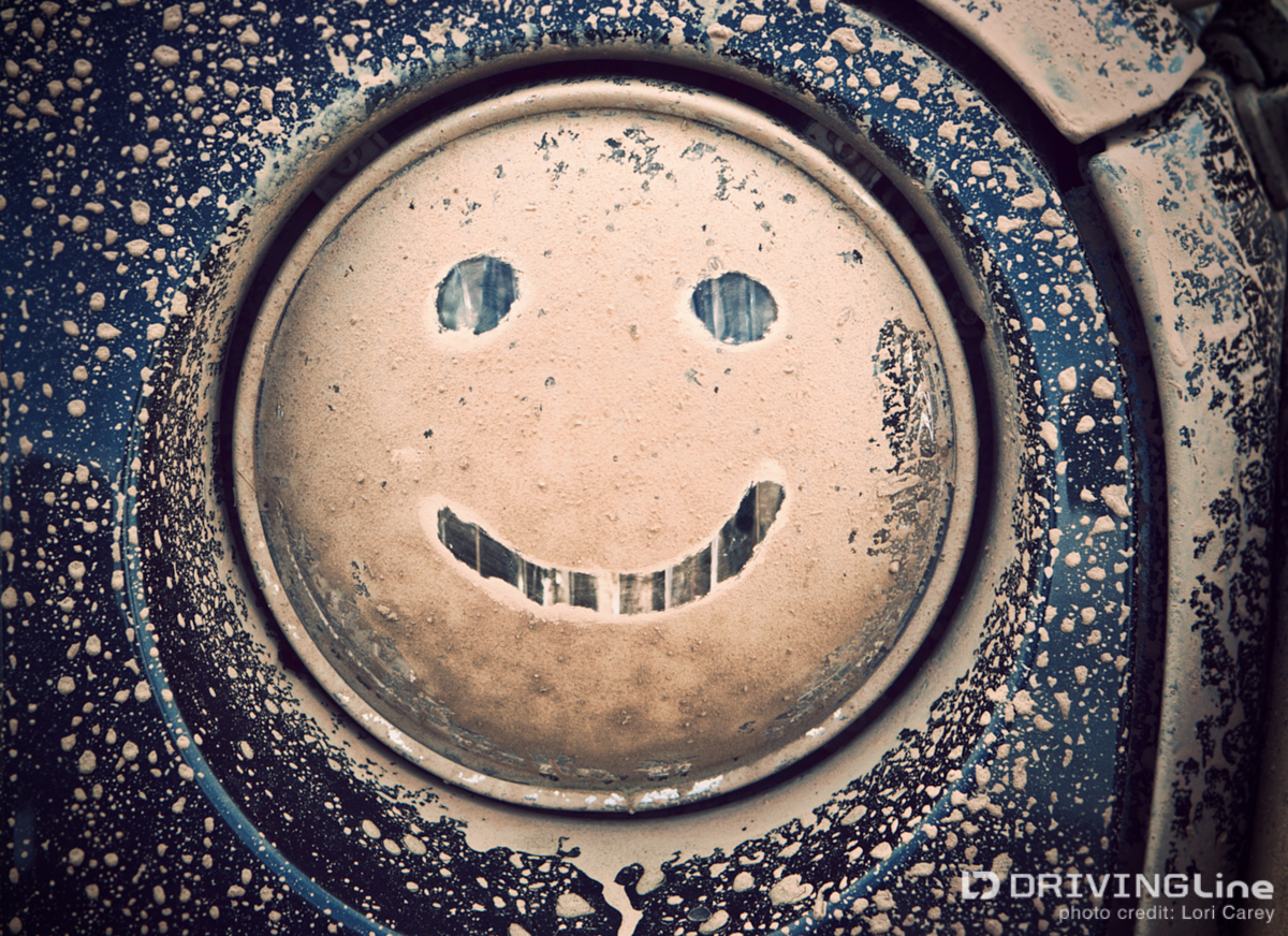 Smiley face on muddy Jeep headlight