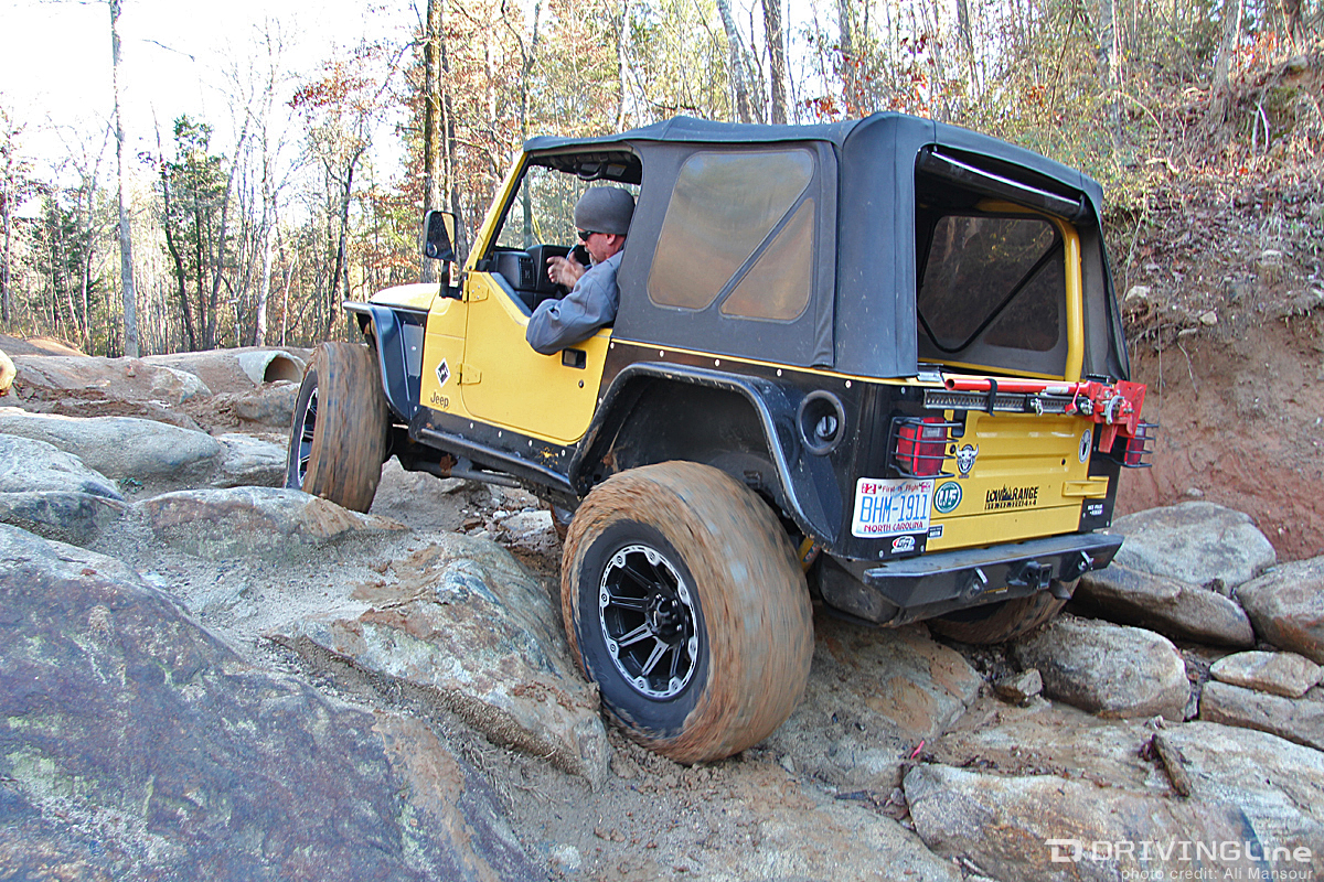  Jeep Wrangler TJ with a soft top rock crawling on a trail