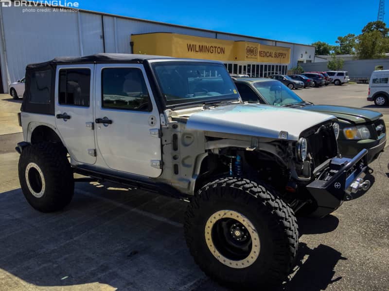 Silver Jeep Wrangler parked outside