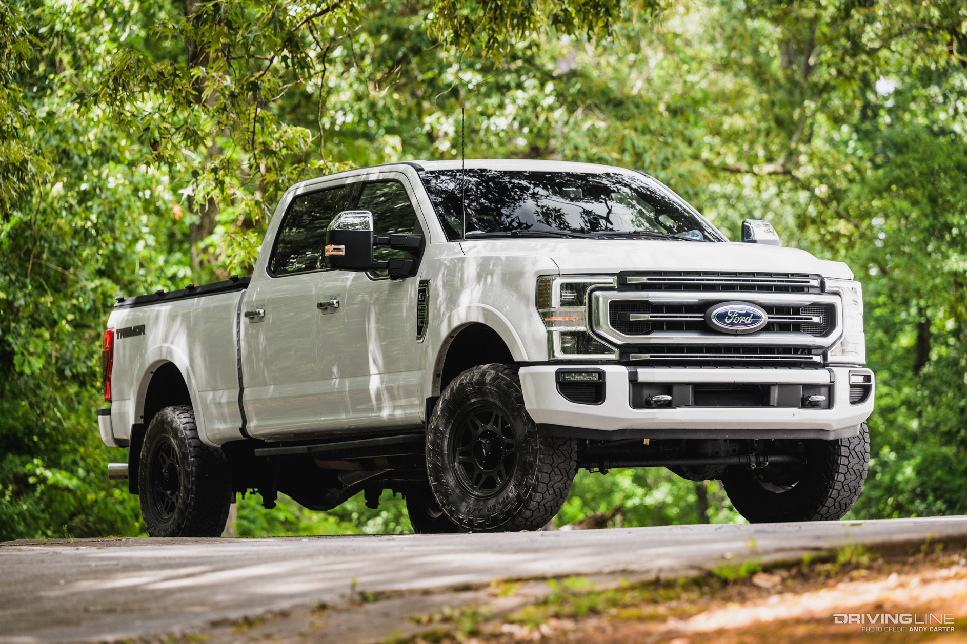 front 3/4 passenger side of white F250 Platinum Tremor with Nitto Recon Grappler Tires