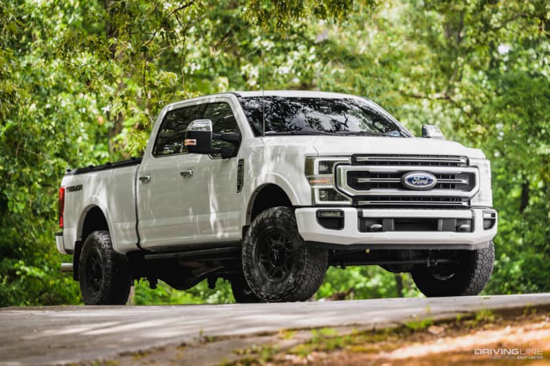front 3/4 passenger side of white F250 Platinum Tremor with Nitto Recon Grappler Tires