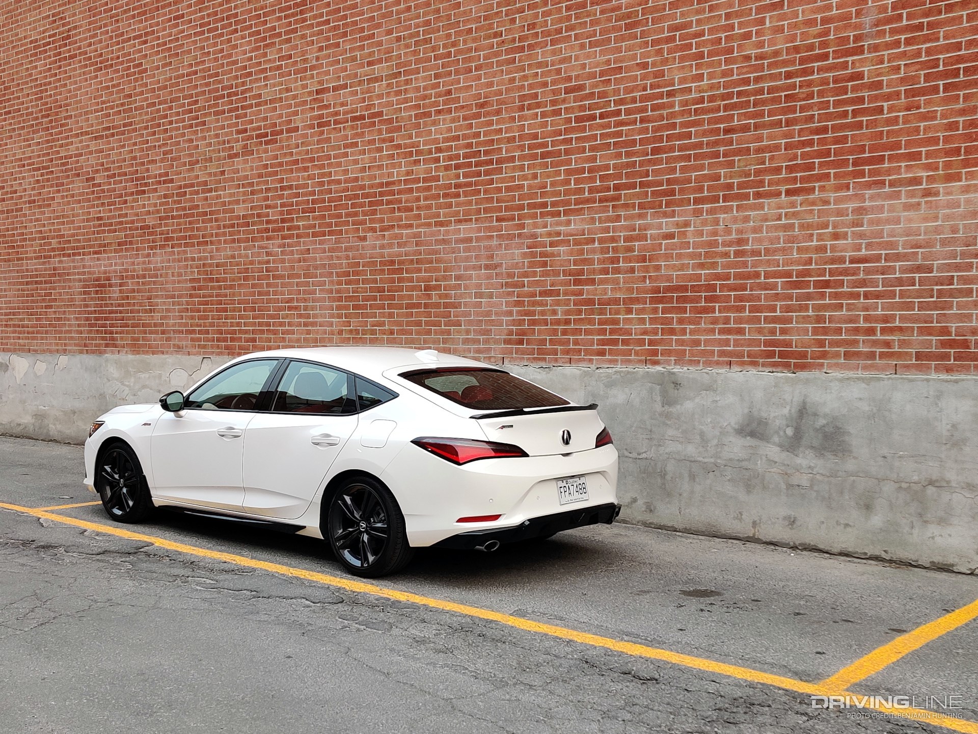 2023 Acura Integra 6MT rear 3/4 view brick wall