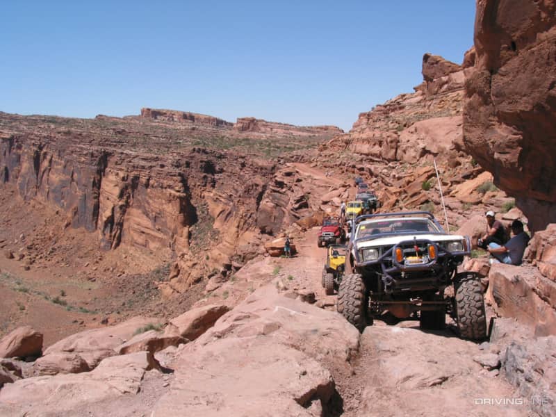 Cliffhanger trail with row of off-road vehicles