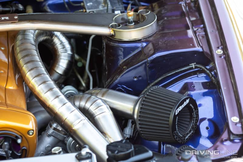 The routing of the intake and turbo piping was very meticulously planned out in the engine bay of Adam LZ's R34 Skyline