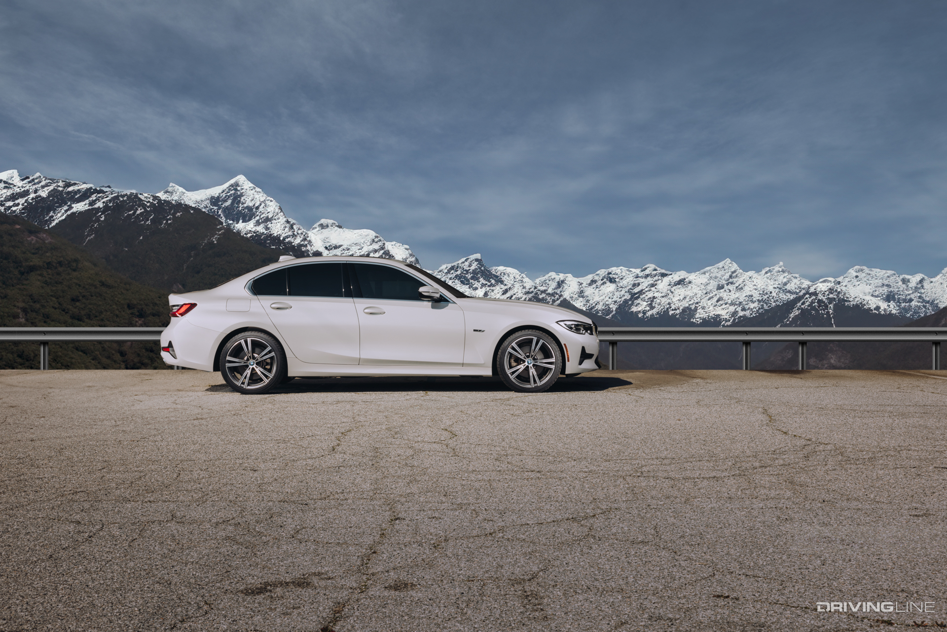 Nitto Motivo 365 All-Season tire on a white BMW in front of snow covered mountains