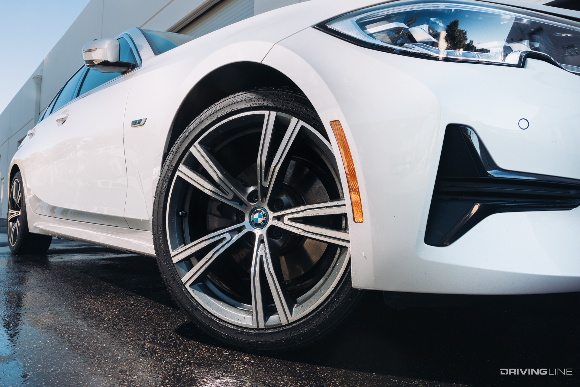 Nitto Motivo 365 All-Season tire on white BMW in wet road conditions