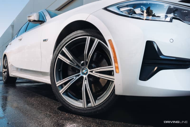 Nitto Motivo 365 All-Season tire on white BMW in wet road conditions