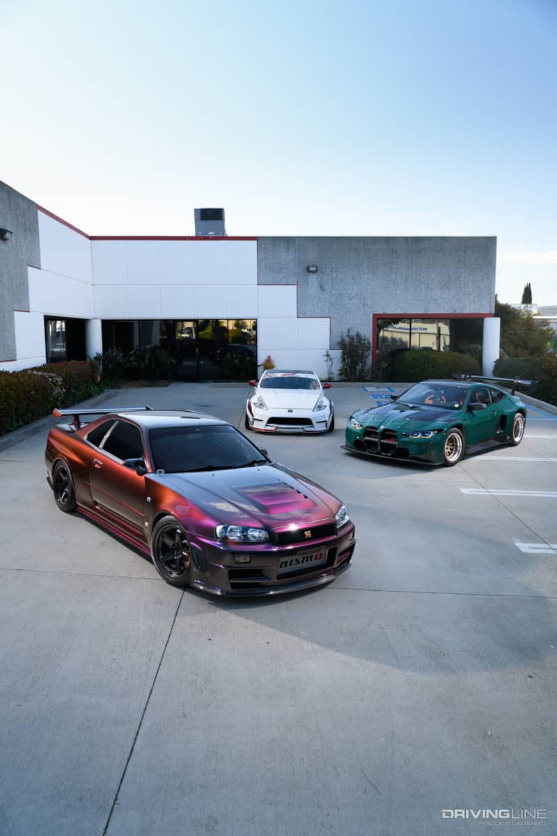 TJ Hunt's R34 GTR, Nissan Z, and BMW M4 GT3 in his parking lot at Hunt & Co Headquarters