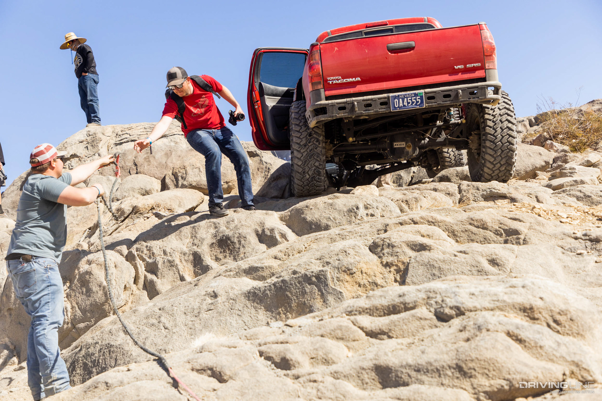 Rear end of red Toyota Tacoma on Trail Grappler tires
