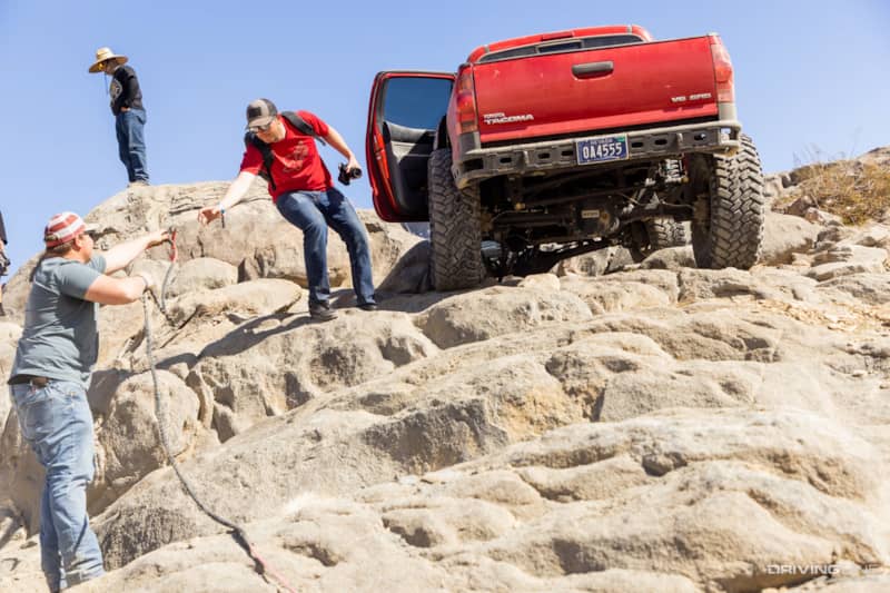 Rear end of red Toyota Tacoma on Trail Grappler tires