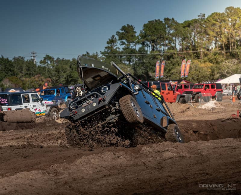 MB Jeep Jam JK on Recon Grapplers jumping out of mud pit