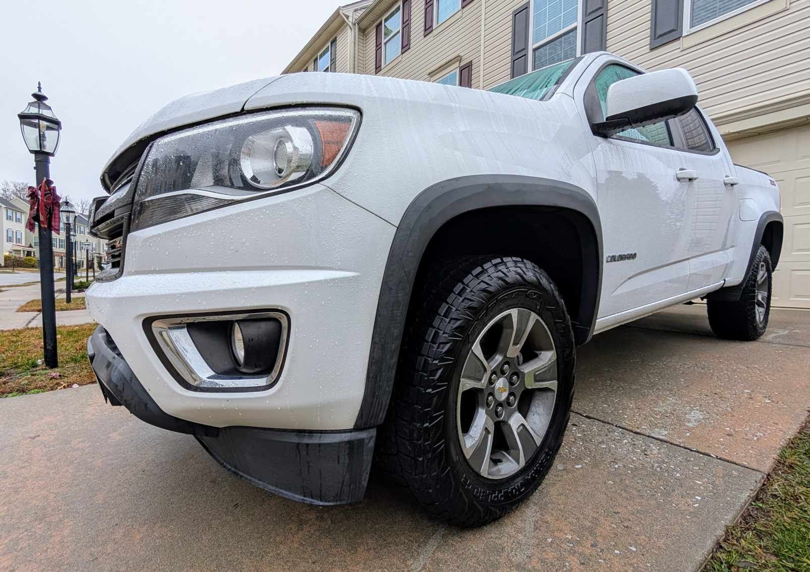 Close up of Nitto Terra Grappler G3 tires on a white Chevy Colorado pickup truck