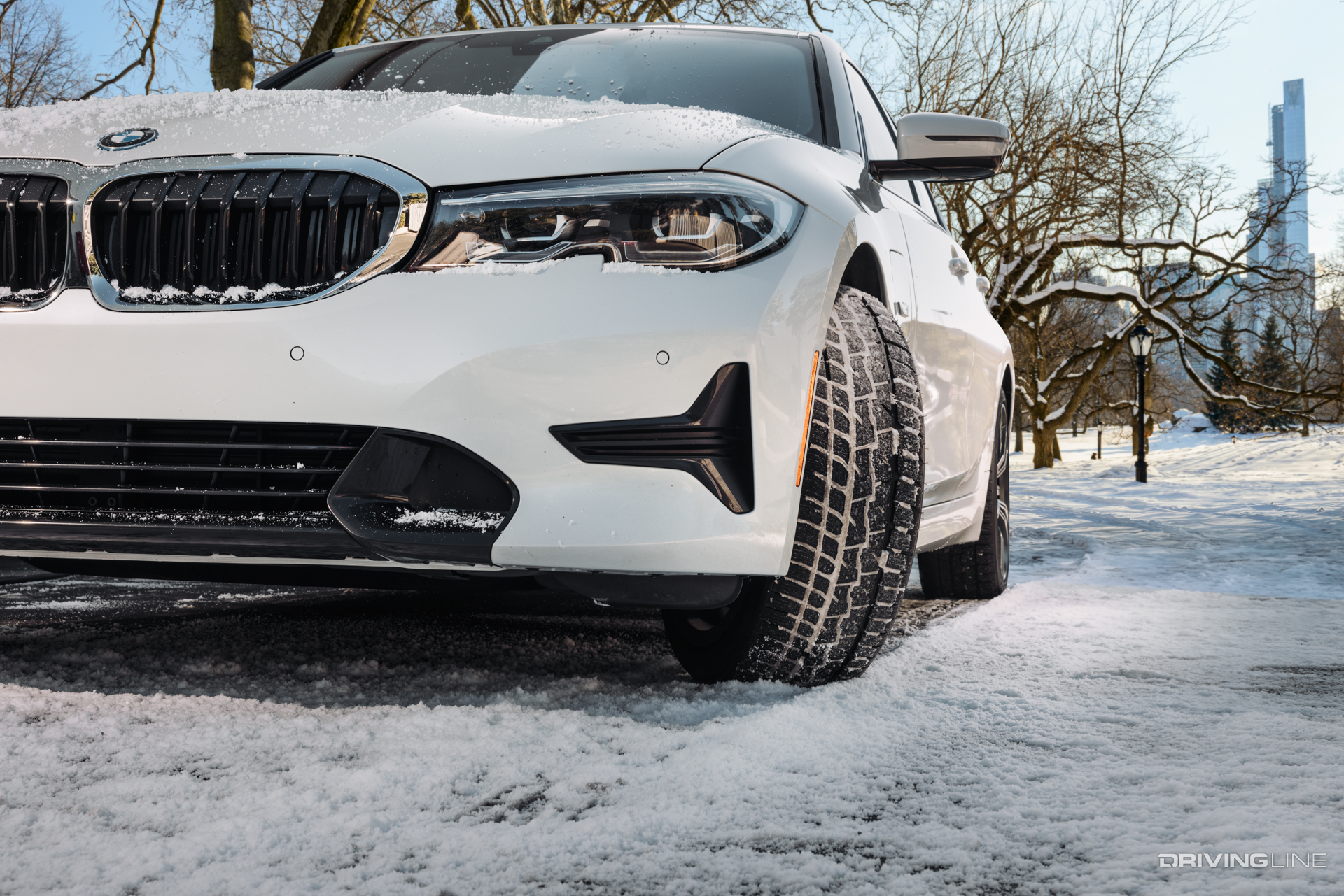 Nitto Motivo 365 tire on white BMW in light snow