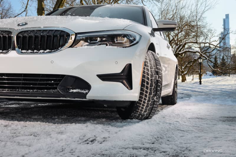 Nitto Motivo 365 tire on white BMW in light snow