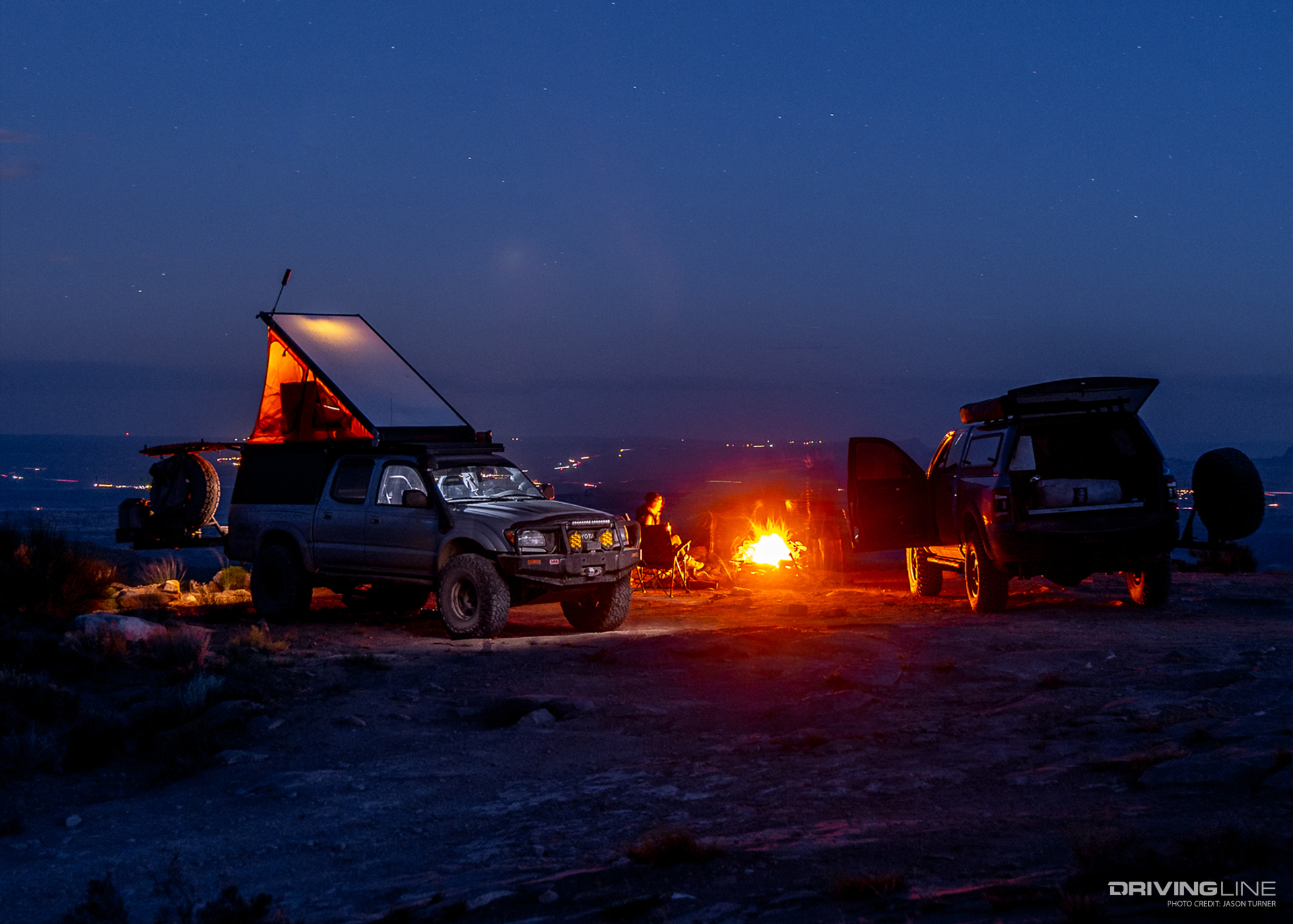 Overlanding go rig camping at night with campfire