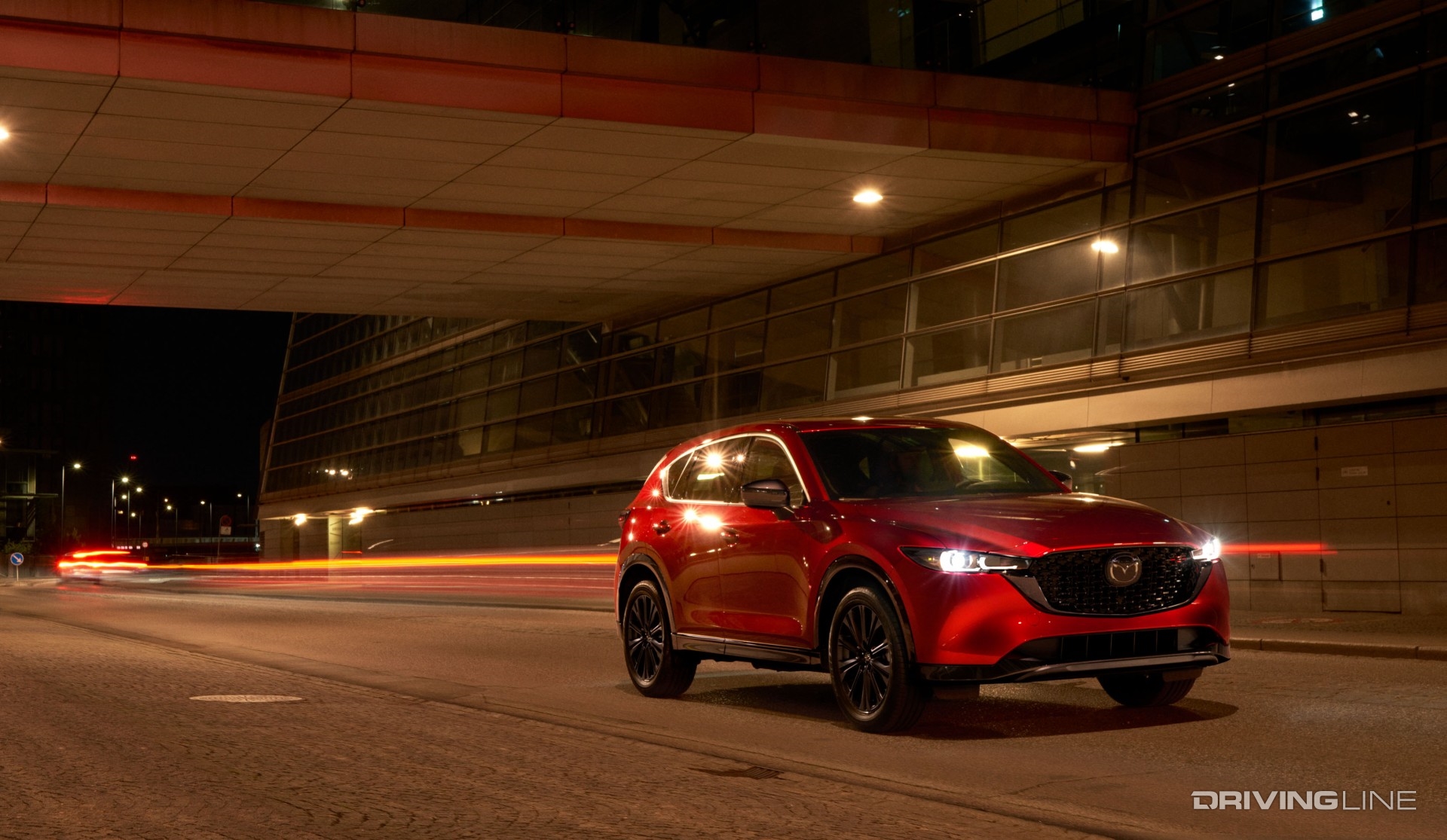 2023 Mazda CX-5 in red at night in motion