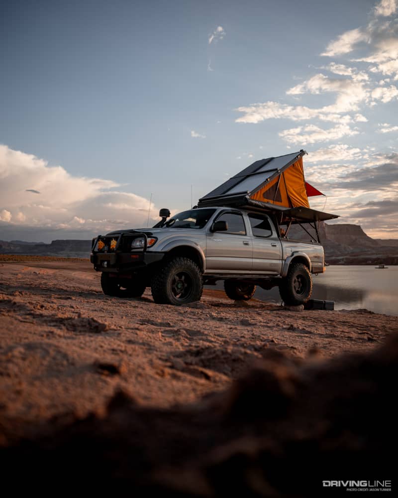 Go Rig overlanding truck with Roof Top tent extended on lake shore