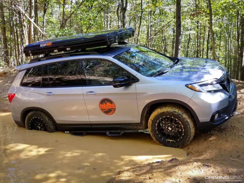 Honda Passport on Nittos in mud pit