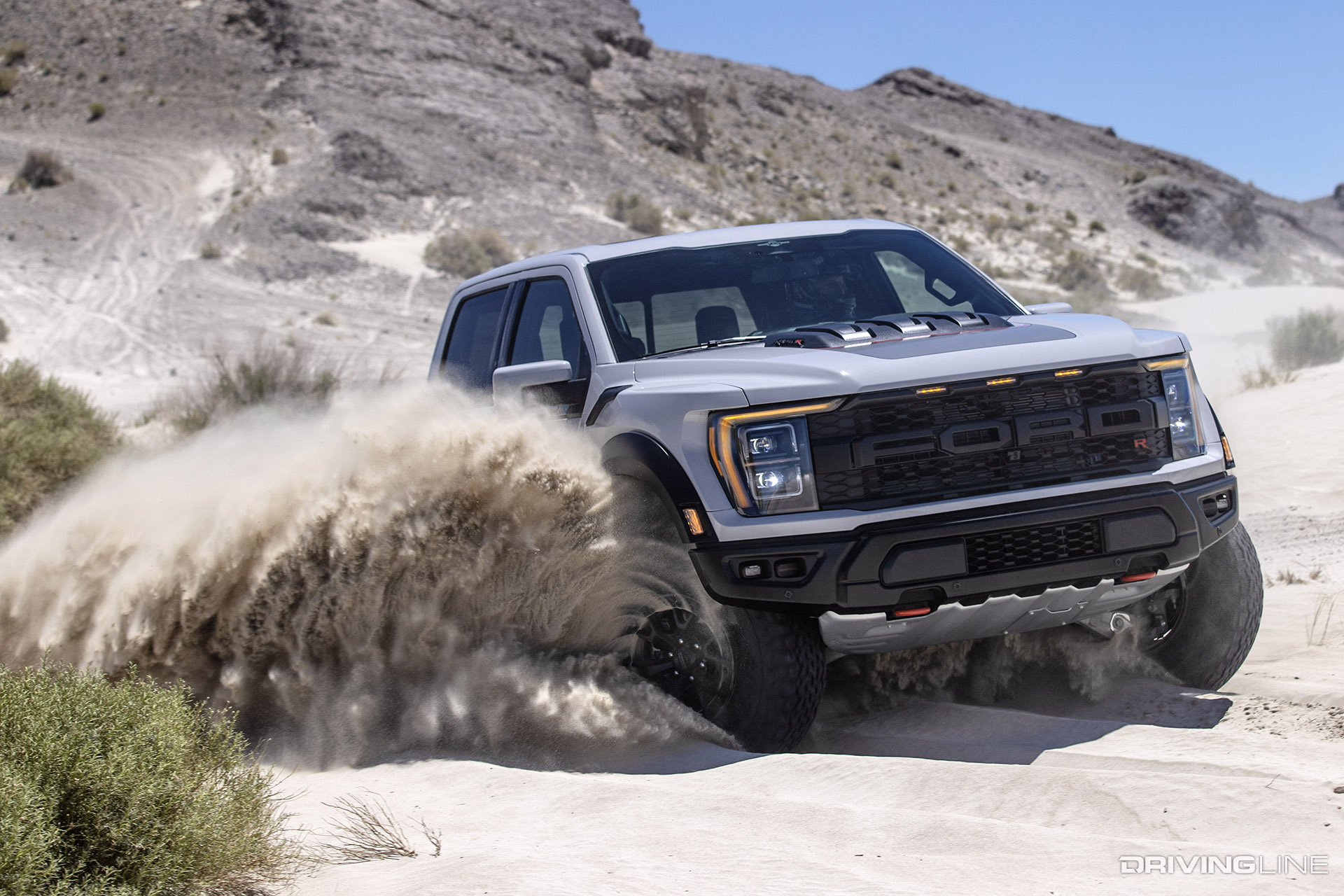 Ford Raptor R splashing through sand